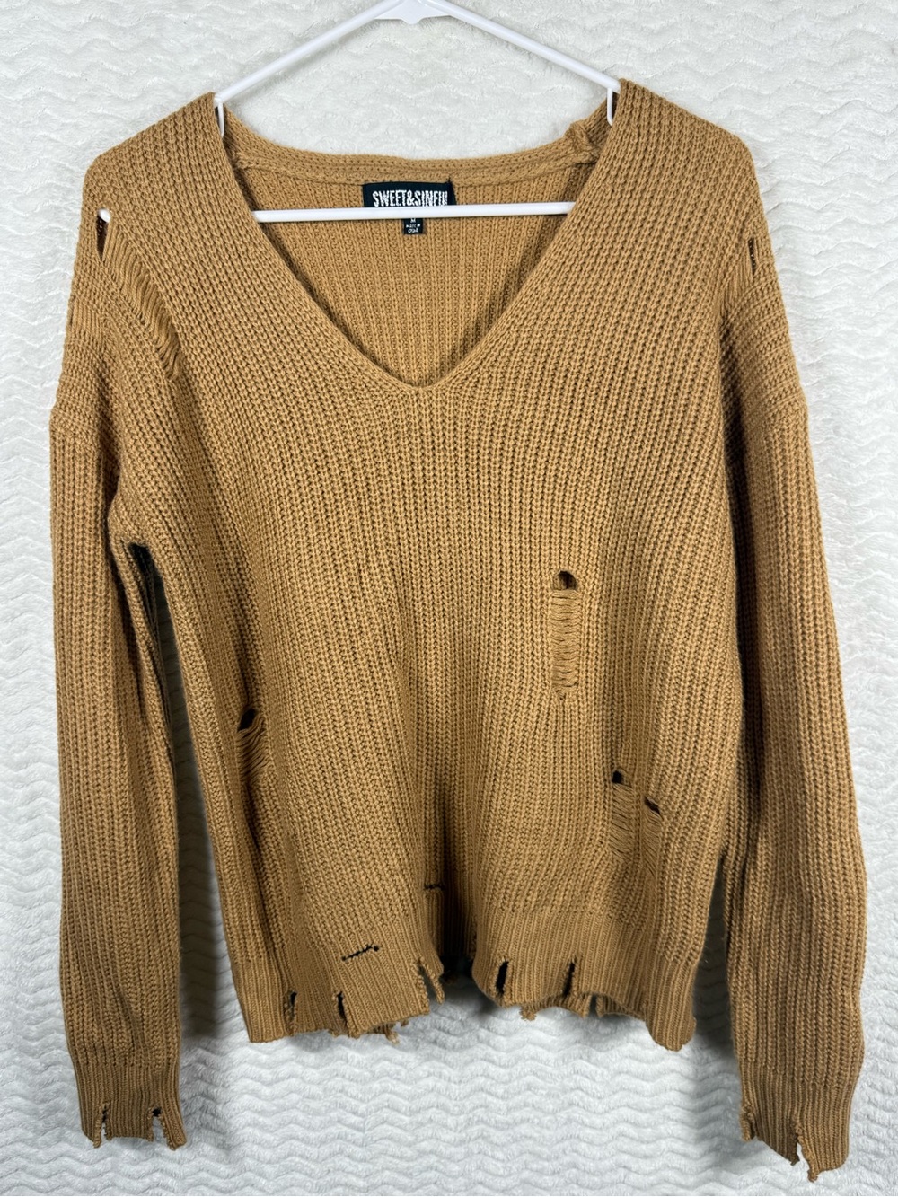 Sweet & Sinful Distressed V-Neck Cozy Knit Sweater in a camel/beige colorway. 🔥🧡